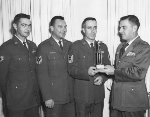 Sembach Air Base Commander Col. D. Brawner accepts trophy from the Sembach Rifle/Pistol team. Left to right: SSgt Dale Mellinger, MSgt Hendershot and MSgt. James Cazel.